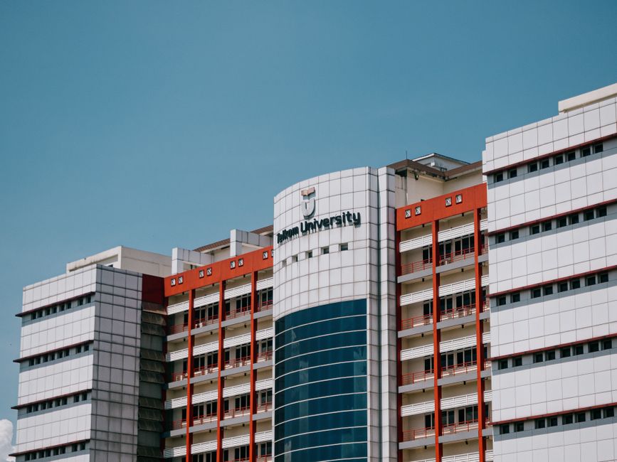 Low angle shot of Telkom University's building facade in Bandung.
