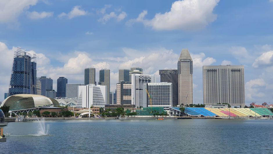 Captivating view of Singapore's iconic skyline and waterfront with a clear blue sky.