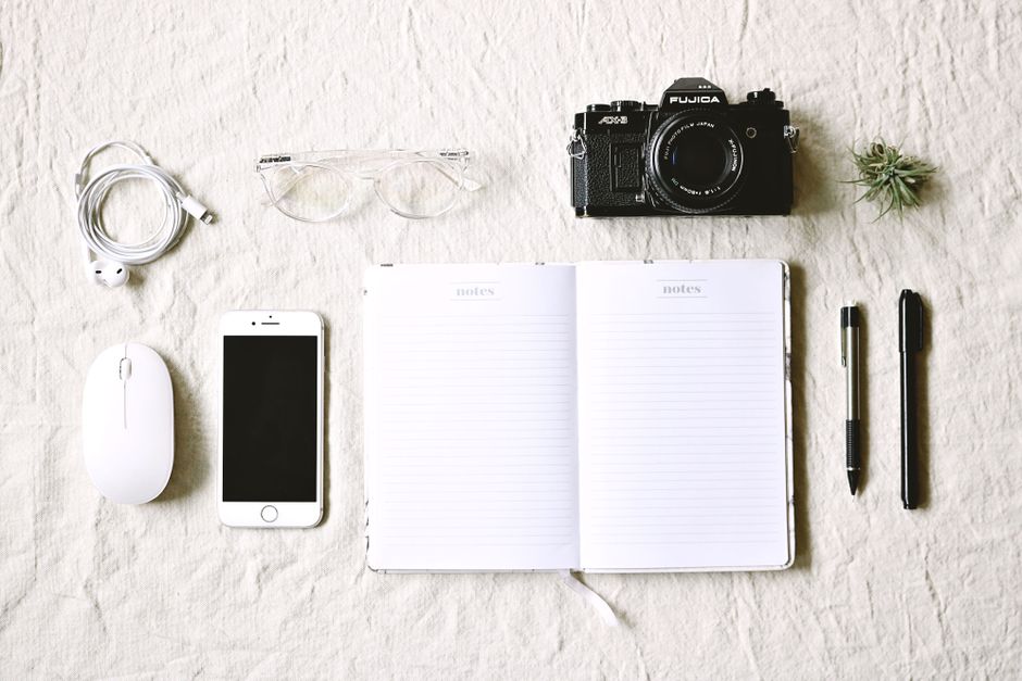 Aesthetic flat lay of vintage camera and modern office supplies, perfect for creative projects.