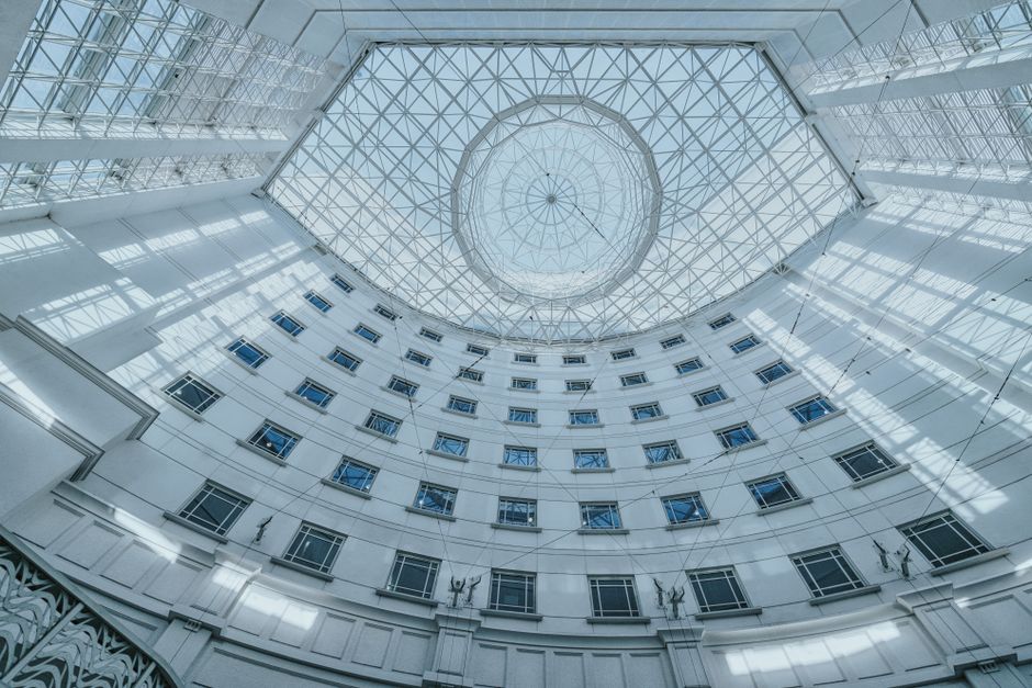 Modern architectural design with a glass skylight in a Singapore atrium, showcasing urban elegance.